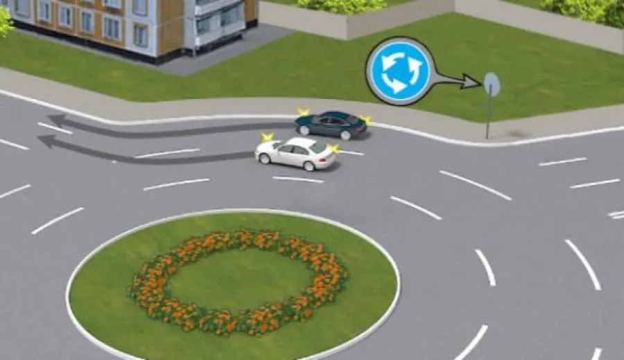 Чи правильно водій білого автомобіля виконав з'їзд із перехрестя з круговим рухом одночасно з водієм синього автомобіля?